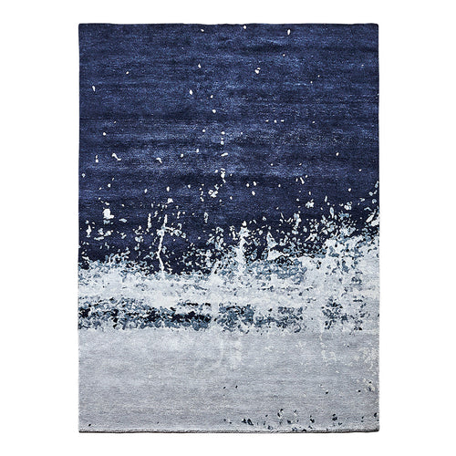 Navy blue and gray abstract area rug with a textured pattern and splashes for a modern touch.