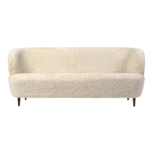 Cream-colored, textured fabric sofa with rounded edges and wooden legs, adding a cozy and modern touch to any space.