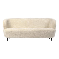 Cozy cream-colored sofa with a textured, shaggy fabric and sleek black legs, perfect for modern interiors.