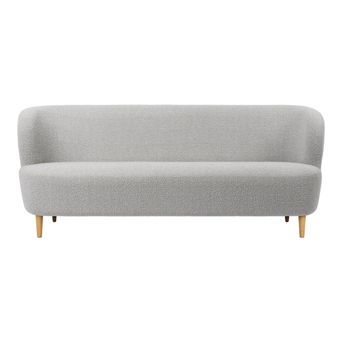 Light gray upholstered sofa with smooth, rounded edges and natural wood legs, featuring a minimalist design.