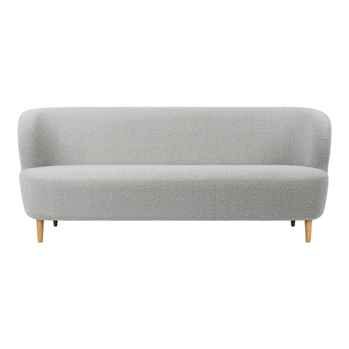 Light gray upholstered sofa with smooth, minimalist design and natural wood legs. Perfect for modern interiors.
