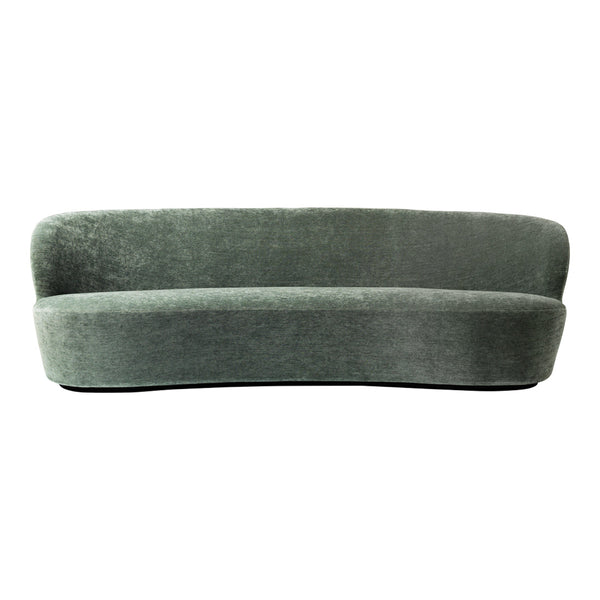Curved, plush sofa in soft, muted green color, featuring a smooth, velvety texture and minimalistic design.