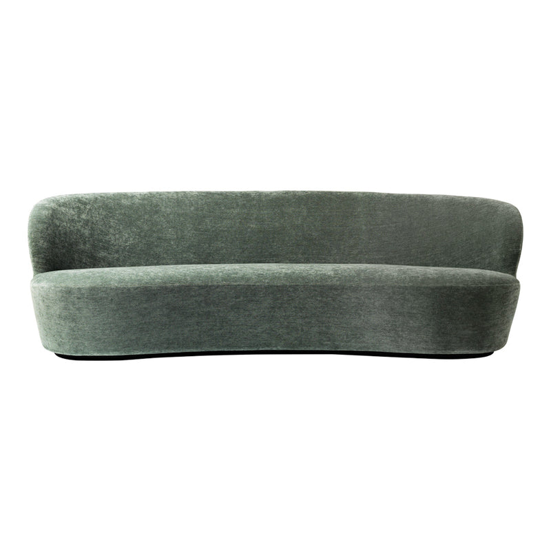 Curved, plush sofa in soft, muted green color, featuring a smooth, velvety texture and minimalistic design.