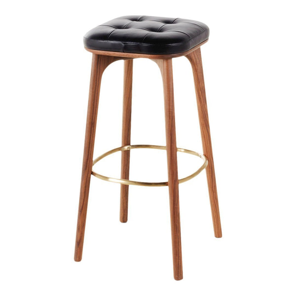Black tufted cushion with walnut wood legs and a brass footrest, featuring a modern, minimalist design.