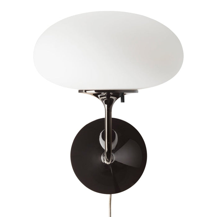 Modern wall lamp with a glossy black base and a smooth, white glass shade. Elegant color contrast and sleek design.