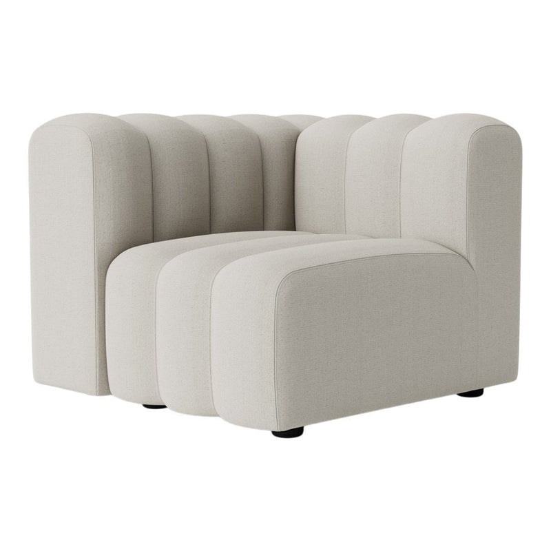 Cream-colored tufted couch with rounded edges and a modern design. Perfect for contemporary decor styles.