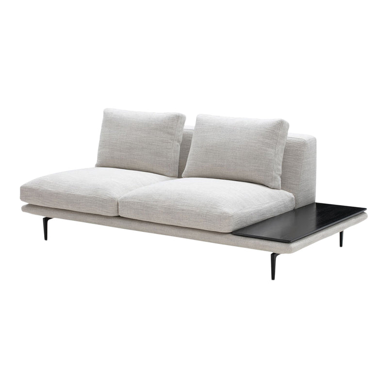 Light gray upholstered sofa with subtle texture and sleek black side table, featuring minimalist design.