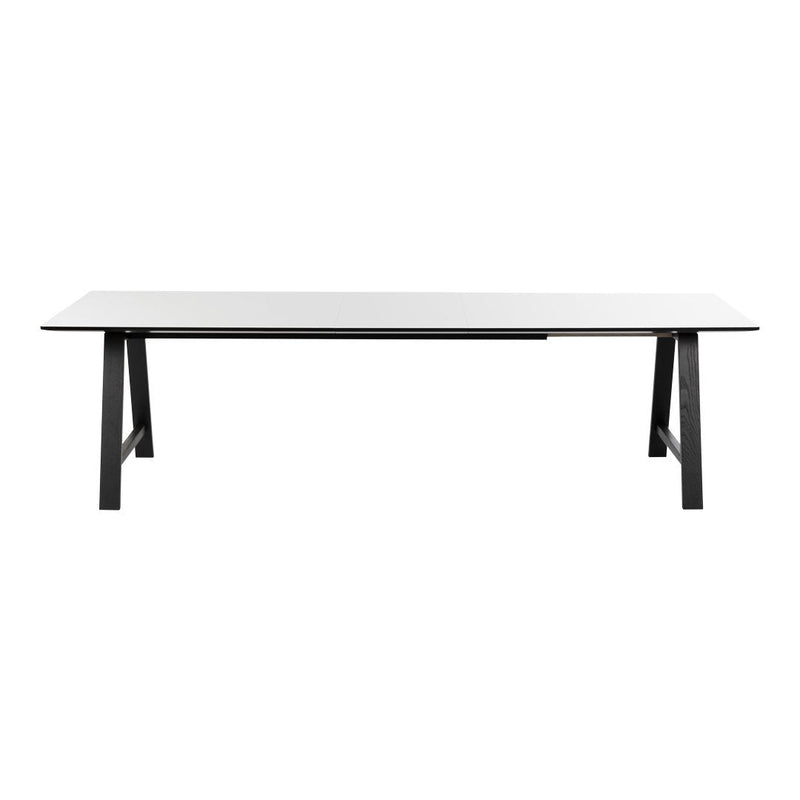 Modern white table with sleek black legs, featuring a minimalist design and smooth surface. Perfect for any decor.