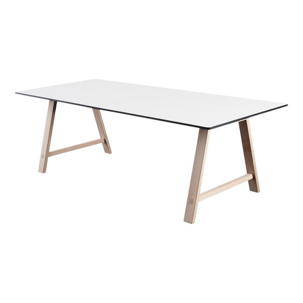 White rectangular table with natural wood legs and a sleek black trim. Perfect for modern home decor.