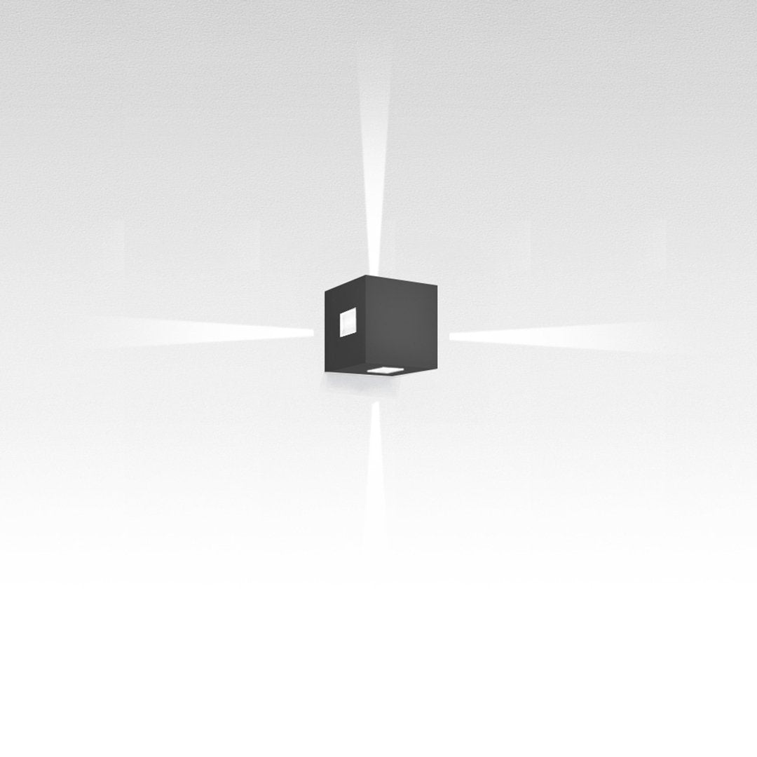 Black cube light fixture casting soft white beams on a minimalist background, ideal for modern decor.