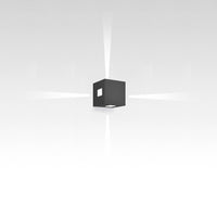 Black cube light fixture casting soft white beams on a minimalist background, ideal for modern decor.
