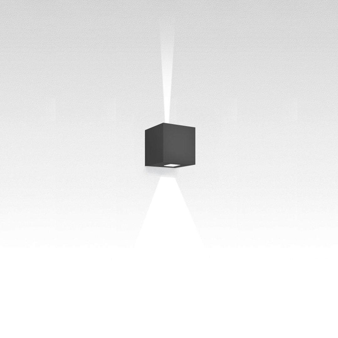 Sleek black cube pendant light with a clean design, illuminating a subtle white gradient background.