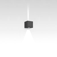 Sleek black cube pendant light with a clean design, illuminating a subtle white gradient background.