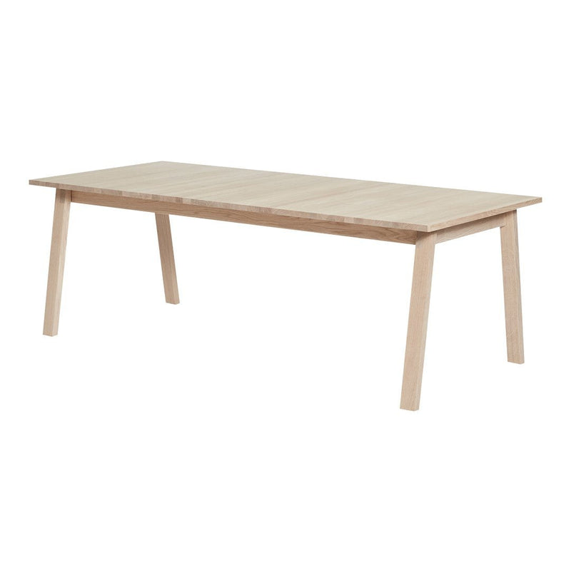 Light wood dining table with a natural finish and minimalist design, featuring clean lines and a smooth surface.