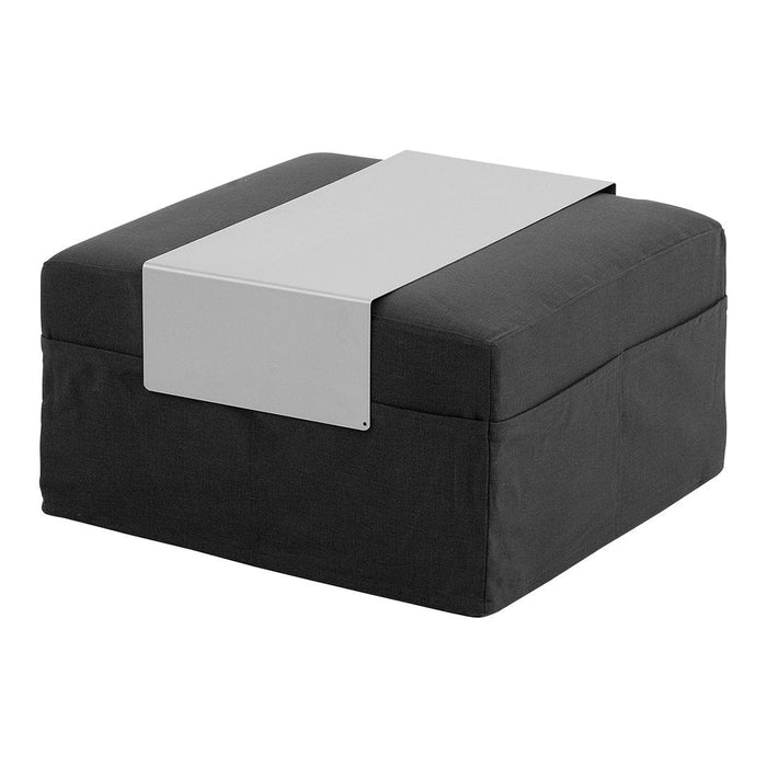 Black upholstered ottoman with a sleek silver metal accent strip on top. Modern and minimalist design.