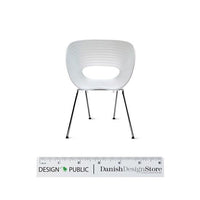 White ribbed chair with a sleek modern design and chrome legs, showcasing a stylish and minimalist aesthetic.