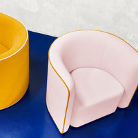 Vibrant yellow and soft pink accent chairs with clean lines on a bold blue background. Modern, stylish, and colorful design.