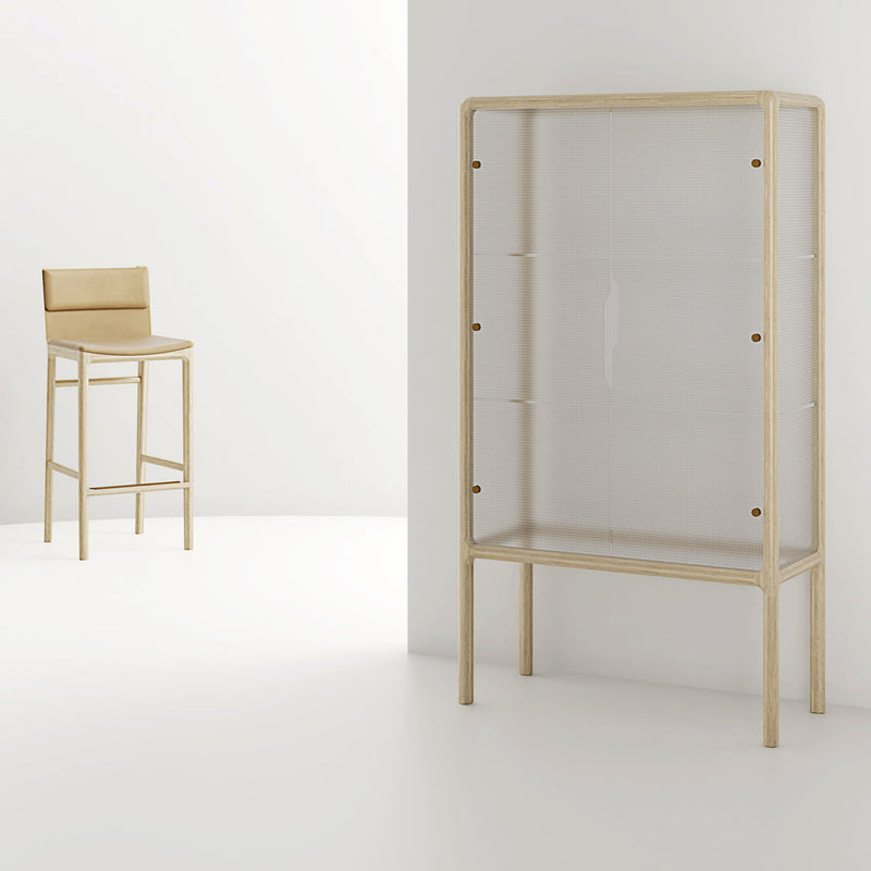 Minimalist beige and glass display cabinet with a matching bar stool in a bright, modern setting. Elegant and stylish design.