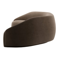 Curved brown velvet lounge chair with a smooth, minimalist design and contrasting light seat cushion.