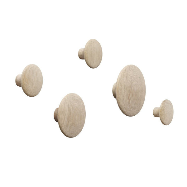 Set of five natural wooden wall hooks in light beige tones with smooth, rounded patterns.
