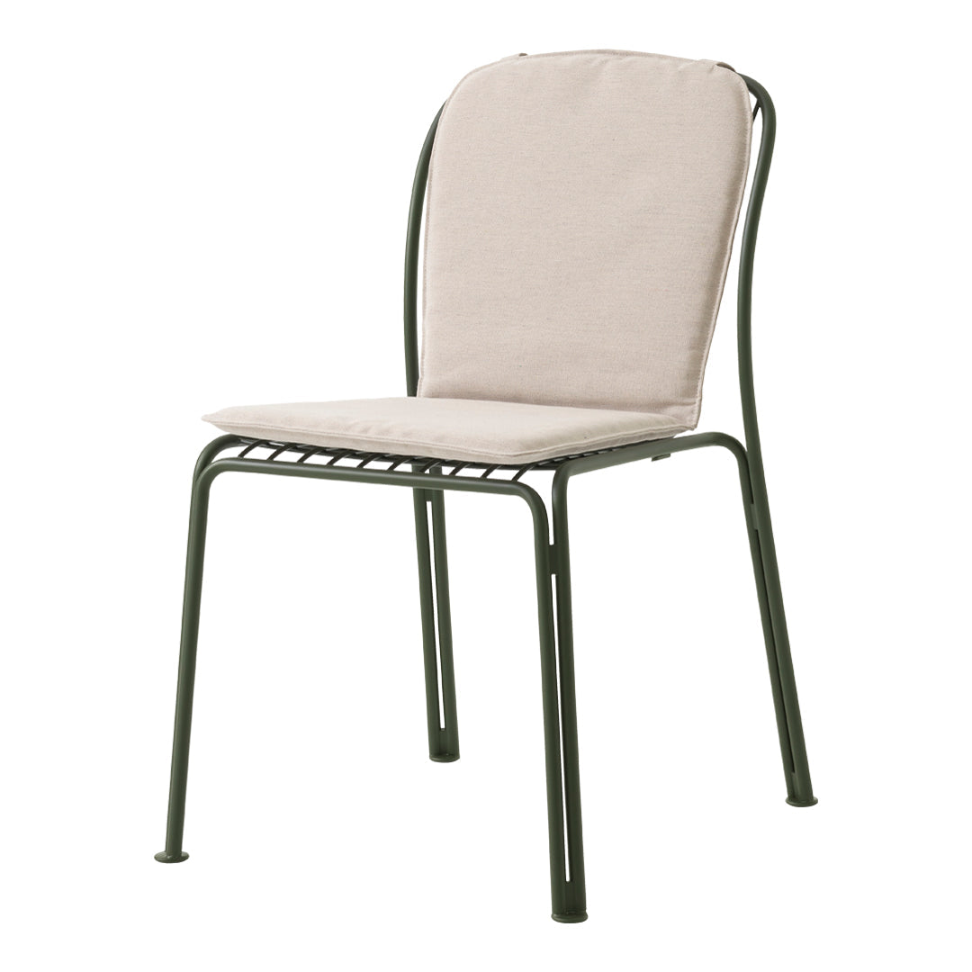 Beige cushion on a green metal chair, featuring a simple, modern design with clean lines and a minimalist aesthetic.