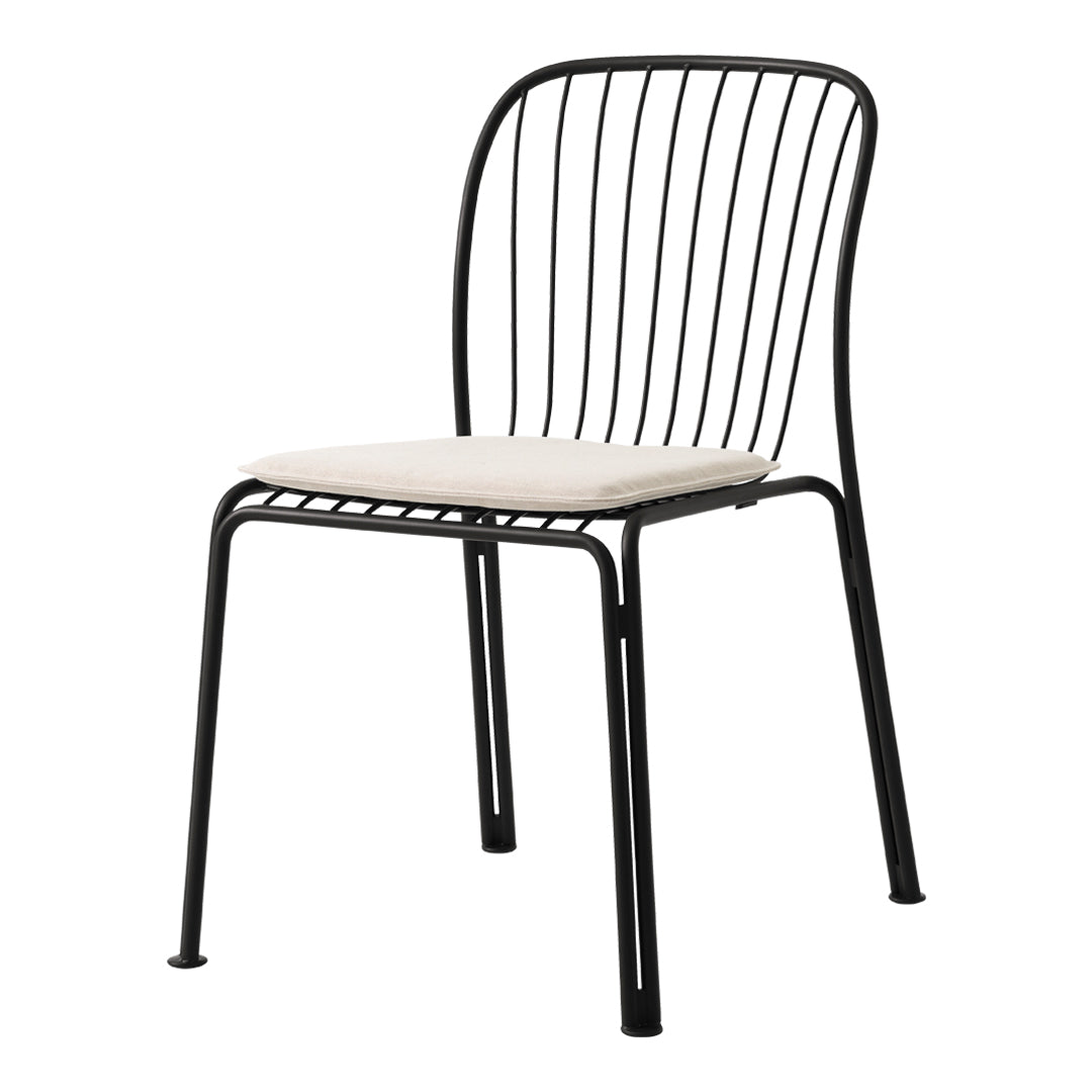 Black metal chair with sleek wire design and cream cushion seat, perfect for modern decor.