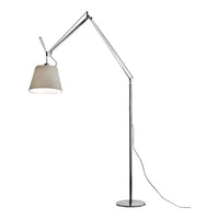 Floor lamp with a sleek chrome finish and a soft beige shade, featuring a minimalist design and adjustable arm.