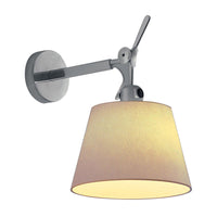 Chrome wall-mounted lamp with a soft beige shade, creating a warm, inviting glow. Perfect for modern interiors.
