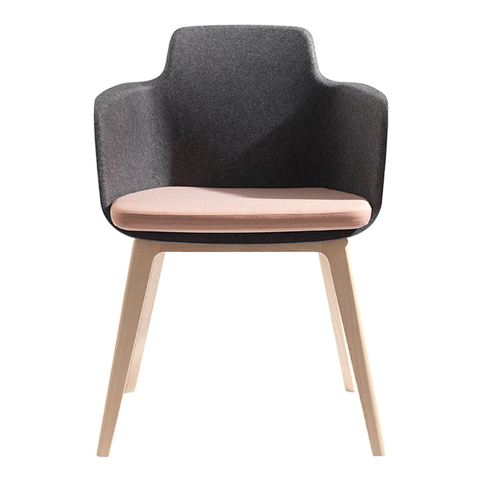 Black upholstered chair with a light pink seat and natural wood legs, combining modern design with subtle color contrasts.