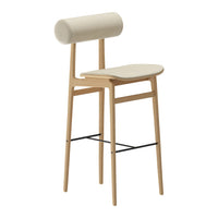 Cream-colored bar stool with a cylindrical backrest and a simple, modern design featuring natural wood legs.