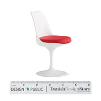 White tulip chair with a vibrant red seat, showcasing a sleek, modern design and smooth finish.