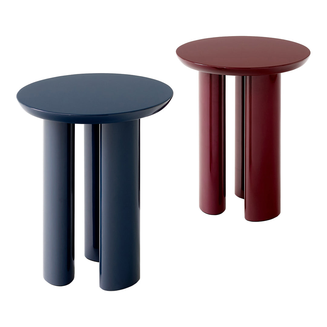 Round side tables in navy blue and deep burgundy with glossy finishes and minimalist design.