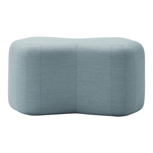 Soft blue upholstered ottoman with a textured, subtle pattern, featuring a modern, unique shape.