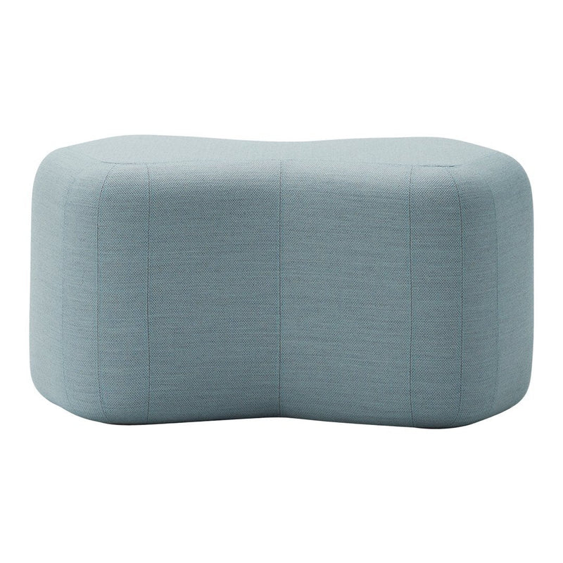 Soft blue upholstered ottoman with a textured, subtle pattern, featuring a modern, unique shape.