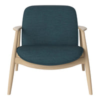 Teal upholstered chair with a smooth texture and light wood frame, ideal for modern interiors.