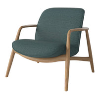 Teal upholstered chair with a textured fabric and natural wood legs, featuring a minimalist design and smooth contours.