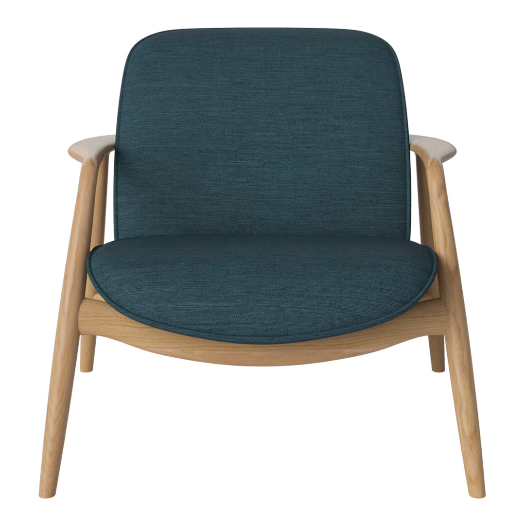 Teal upholstered chair with a smooth texture and light wood legs, showcasing modern minimalist design.