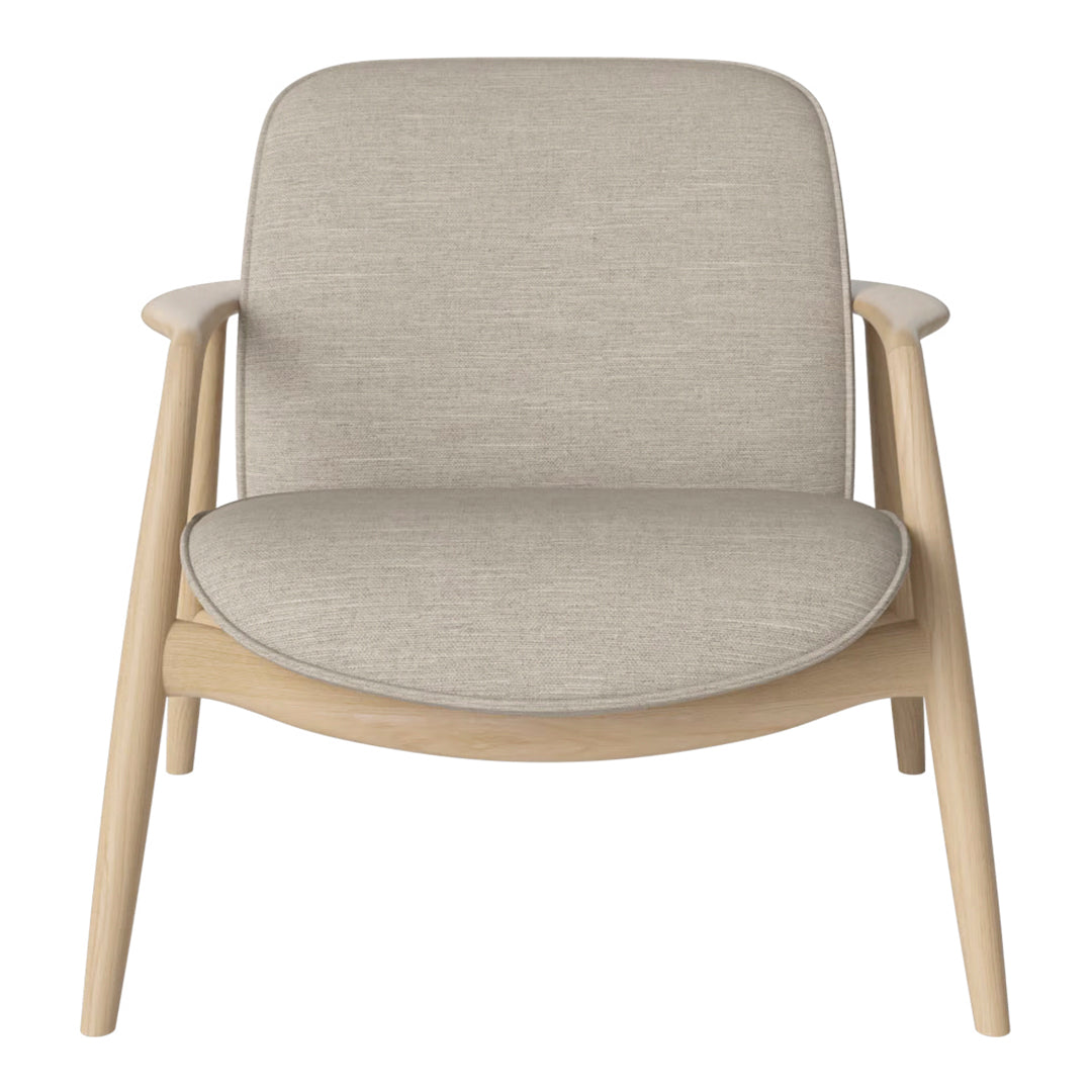 Beige fabric armchair with smooth contours and light wooden legs, perfect for modern and minimalist decor.