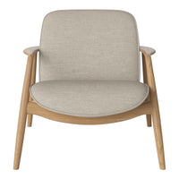 Light gray upholstered chair with a smooth, curved seat and natural wood legs, showcasing a minimalist design.