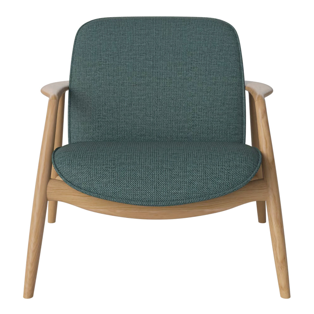 Teal upholstered armchair with a textured fabric and light wooden legs, adding a modern touch to any space.