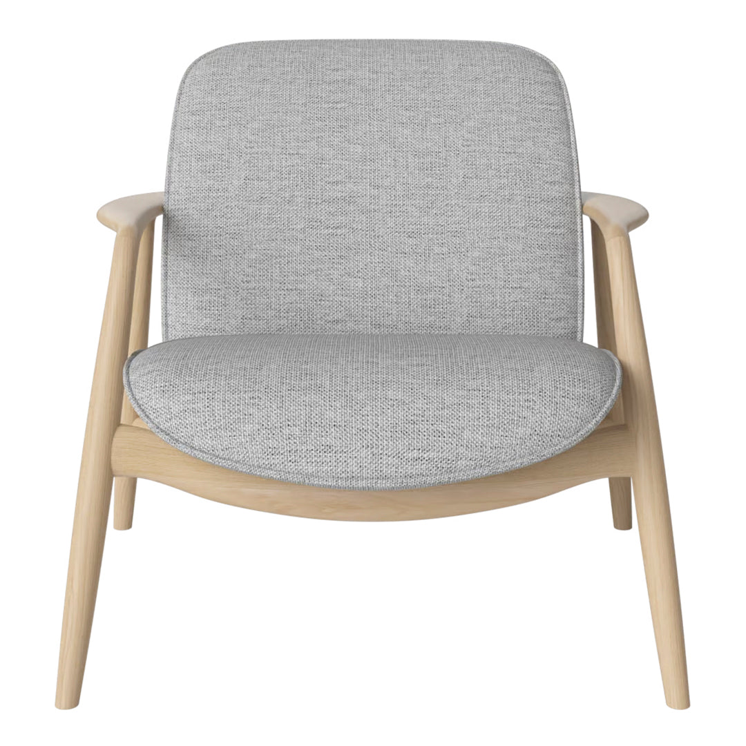 Light gray fabric armchair with smooth, minimalist design and natural wood frame. Perfect for modern interiors.