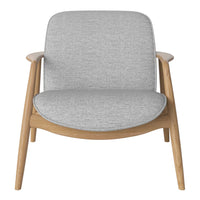 Light gray upholstered chair with a minimalist design and warm wooden frame, perfect for modern decor.