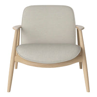 Light beige upholstered chair with smooth, minimalist design and natural wood legs. Perfect for modern decor.