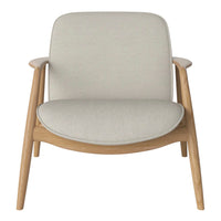 Light gray upholstered chair with a smooth, minimalist design and natural wood legs, showcasing a modern aesthetic.