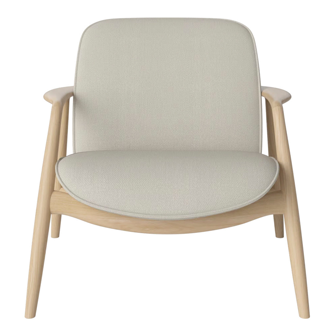 Light beige armchair with a smooth, minimalist fabric upholstery and natural wood frame. Simple, modern design.