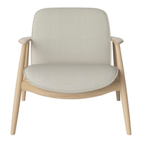 Light beige armchair with a smooth, minimalist fabric upholstery and natural wood frame. Simple, modern design.