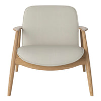 Neutral beige fabric armchair with light wood legs, showcasing a minimalist, contemporary design.