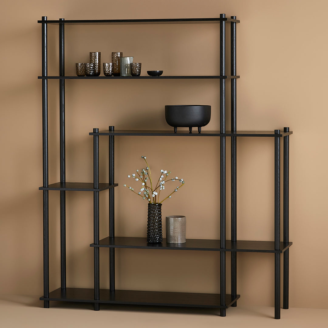 Black metal shelving unit on a beige background, featuring geometric patterns and sleek lines. Perfect for modern decor.