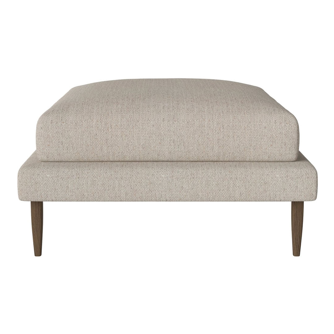 Neutral beige upholstered ottoman with a smooth texture and tapered wooden legs, perfect for modern decor.