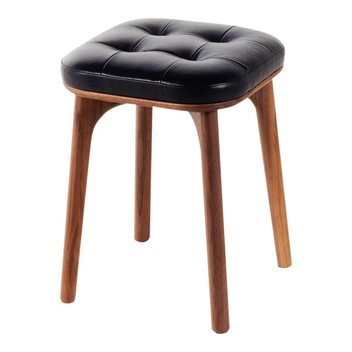 Black tufted leather stool with wooden legs, featuring a sleek modern design and smooth texture.